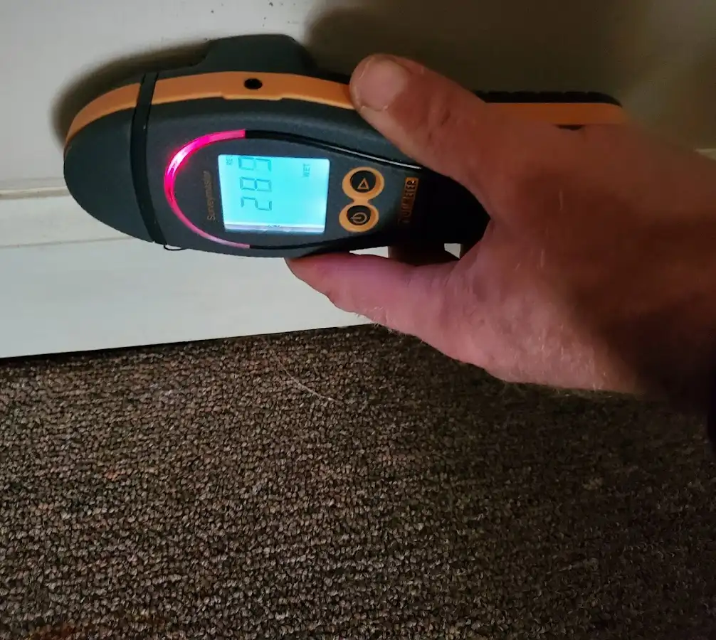 Moisture detection at baseboard during Storm Damage Restoration in South Elgin